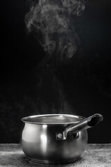 steam over cooking pot on black background, Hot food. Bowl of hot steam with smoke, Culinary, cooking, concept