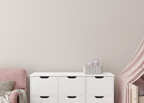 Empty cream wall in modern child room. Mock up interior in scandinavian style. Copy space for your picture or poster. Sideboard, toys. Close up view. Cozy room for kids. 3D rendering.