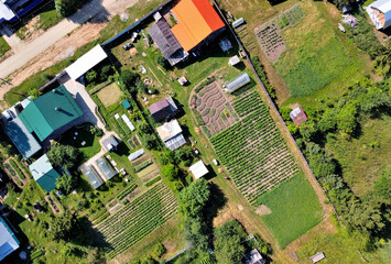 A fragment of a panorama of a small rural settlement on a summer day - obrazy, fototapety, plakaty