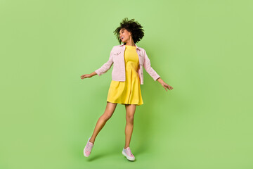 Full length portrait of excited cheerful lady enjoy free time freedom good mood isolated on green...