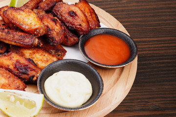 Grilled chicken wings on a wooden cutting board