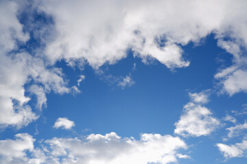 Sky with clouds and sun. White colour clouds against blue sky