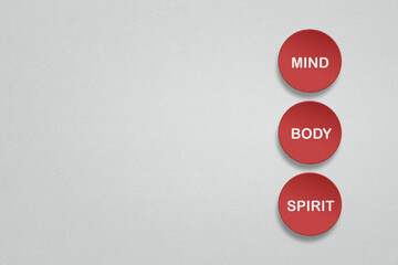 body, mind and spirit on grunge red circle paper cut on gray paper texture with copy space