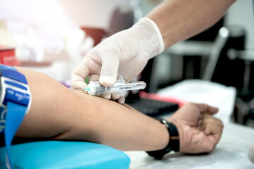 Close up hand of nurse, taking blood sample from a patient in the hospital.	