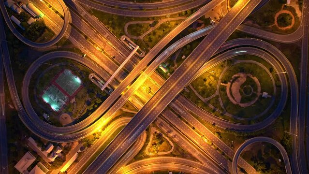 Stunning night aerial view drone shot above interchange and multi junction road. time lapse traffic night. Hyperlapse. drone 4K. Thailand
