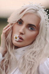 Portrait of a Slavic girl with daisies.