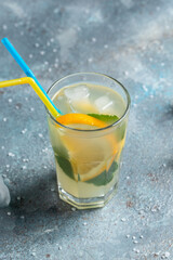 Summer sparkling cocktails. Hard seltzer cocktails with lemon, orange and mint. Glass of cold drink. vertical image. place for text