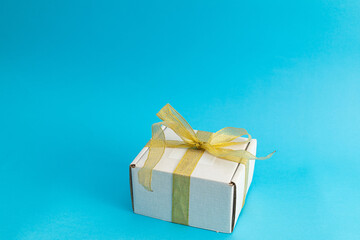 White holiday gift box on blue background