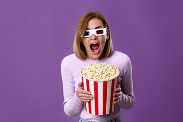 woman watching movie film, holding bucket of popcorn