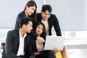 Fototapeta premium A group of young Asian businessman and women Talking and planning work happily and have fun. at the company's office