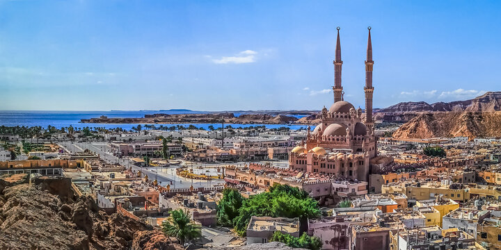 Wide angle drone panorama of Sharm El Sheikh coastline with Al Sahaba Mosque among exotic Egyptian architecture. Beautiful tropical cityscape