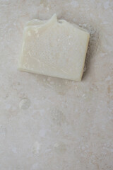 Natural bar soap for healthy skin and hair.
Hydrating cleansing bar on stone textured plain background.