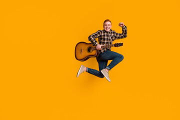 Full length photo of young guy jumper active celebrate luck fists hand play guitar concert isolated...