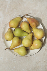 Organic grow june beauty pears in plate, top view