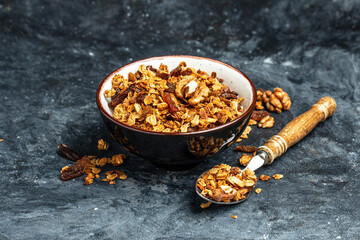 Fototapeta premium Bowl with granola on a blue background. superfood concept. Healthy, clean eating. Vegan or gluten free diet. Long banner format. top view