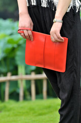 Closeup of fashion chinese woman with red handbag