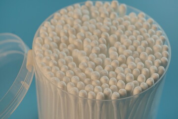 Hygienic cotton swabs in a package on a blue background.