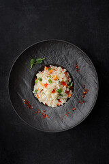 Risotto with vegetables and spices on a plate. vertical