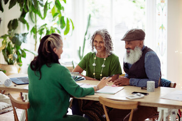 Happy couple meeting with interior designer at home