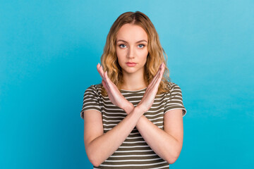 Portrait of strict woman show stop gesture crossing arms wear casual shirt isolated on blue color background