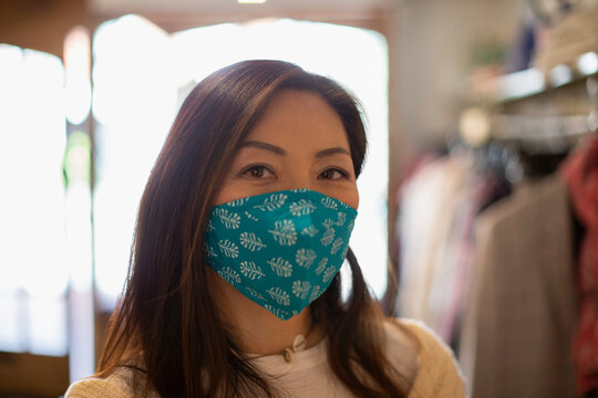 Portrait confident woman wearing face mask in shop