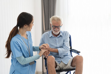 Obraz premium Nurse and patient senior man on wheelchair. Nurse caring senior man sitting on wheelchair at hospital. Asian nurse taking care old man in wheelchair at home.