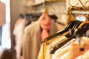 Clothes on hangers in clothing boutique