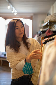 Woman shopping for clothing in boutique