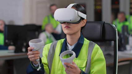 Young woman engineer test vr goggles and controllers in modern industrial laboratory