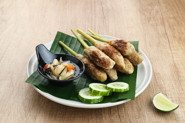 Sate Lilit, traditional Balinese minced chicken satay with lemongrass as skewer, served with sambal matah.
