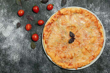 There are a pizza on the grey table.