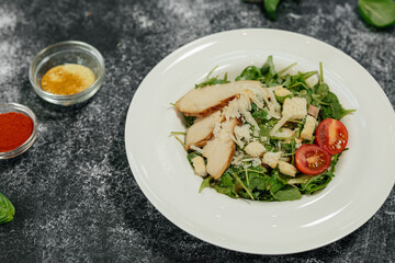 There are two dishes on the grey table.