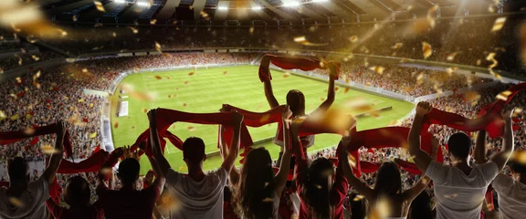 Wall murals Best sellers Sport Back view of football, soccer fans cheering their team with colorful scarfs at crowded stadium at evening time. Concept of sport, support, competition. Out of focus effect