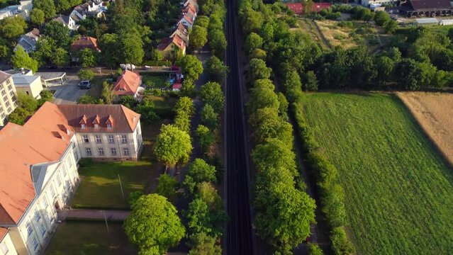 Subway tracks in front of the Geheimes Staatsarchiv Preu&szlig;ischer Kulturbesitz
Tranquil aerial view flight tilt down drone above footagef dom&auml;ne dahlem Berlin, golden hour Summer 2022 by Philipp Marnitz