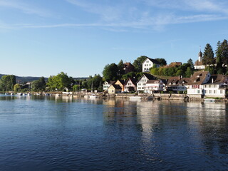 Fototapeta na wymiar Pier at Rhine River in european STEIN AM RHEIN town in SWITZERLAND