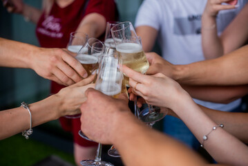 friends clink champagne glasses. Bride with jewelry and wedding ring