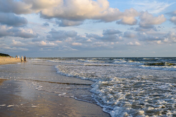 Sand beach with unrecognised people on Baltic sea in Palanga city at summer sunset