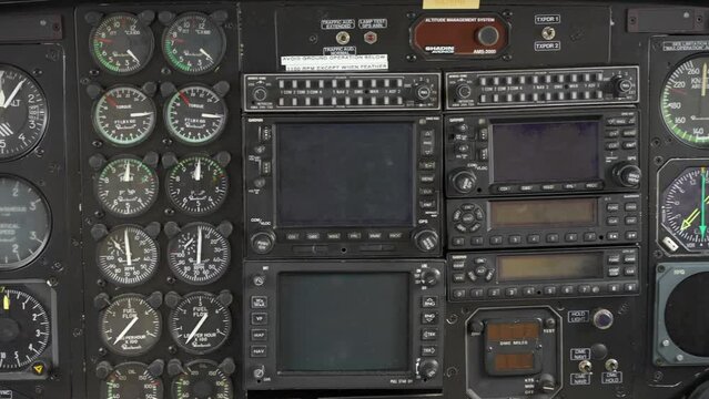 Close-up shot of a dashboard in cabin of small single engine airplane standing in hangar