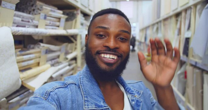 African-American blogger designer make video in wallpaper section of diy store. Realtime
