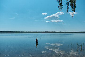 fisherman boy fishing on the lake