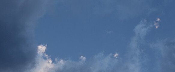 Blue sky with clouds, empty space for text.