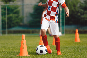 Young boy attending soccer training on school field. Children on physical education class. Soccer practice for children