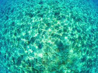Fototapeta na wymiar Top view of colorful azure water with stones and sea water top view background.