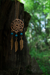 amulet lying on a moss on a dark natural background. pagan wiccan, slavic traditions. Witchcraft,...