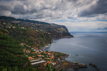 Fototapeta na wymiar Panoramic view from Ponta do Sol village on Madeira island, Madeira, Portugal. October 2021. Long exposure picture.