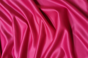 Pink supplex crumpled or wavy fabric texture background. Abstract linen cloth soft waves. Silk fabric. Smooth elegant luxury cloth texture. Concept for banner or advertisement.