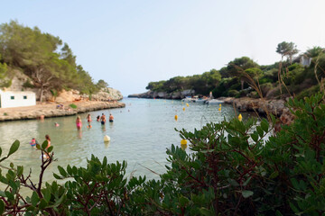 Cala en Blanes, Menorca (Minorca), Spain. Picturesque beach - Platja Cala en Blanes. View through...