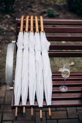 closed white umbrellas for guests at a party
