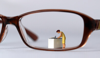 The concept of social prejudice against women. Business concept with glasses and miniature people.
