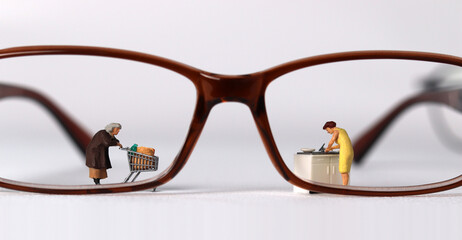 Business concept with glasses and miniature people.
